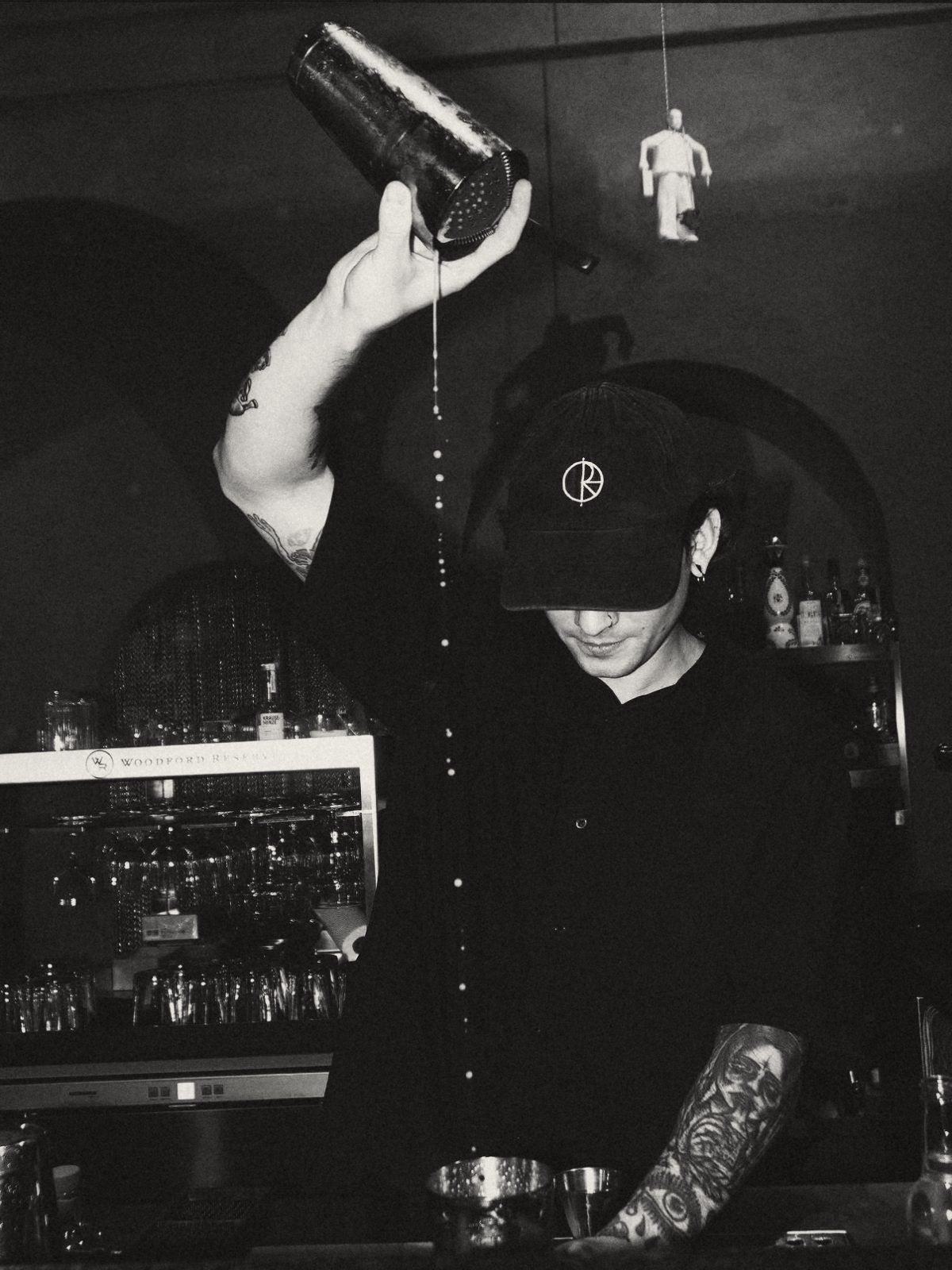 Rodion, bartender, pouring a cocktail