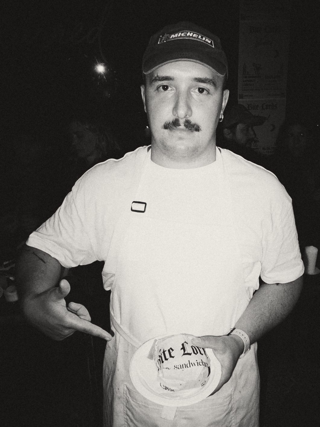 Yurii, chef, holding a sandwich