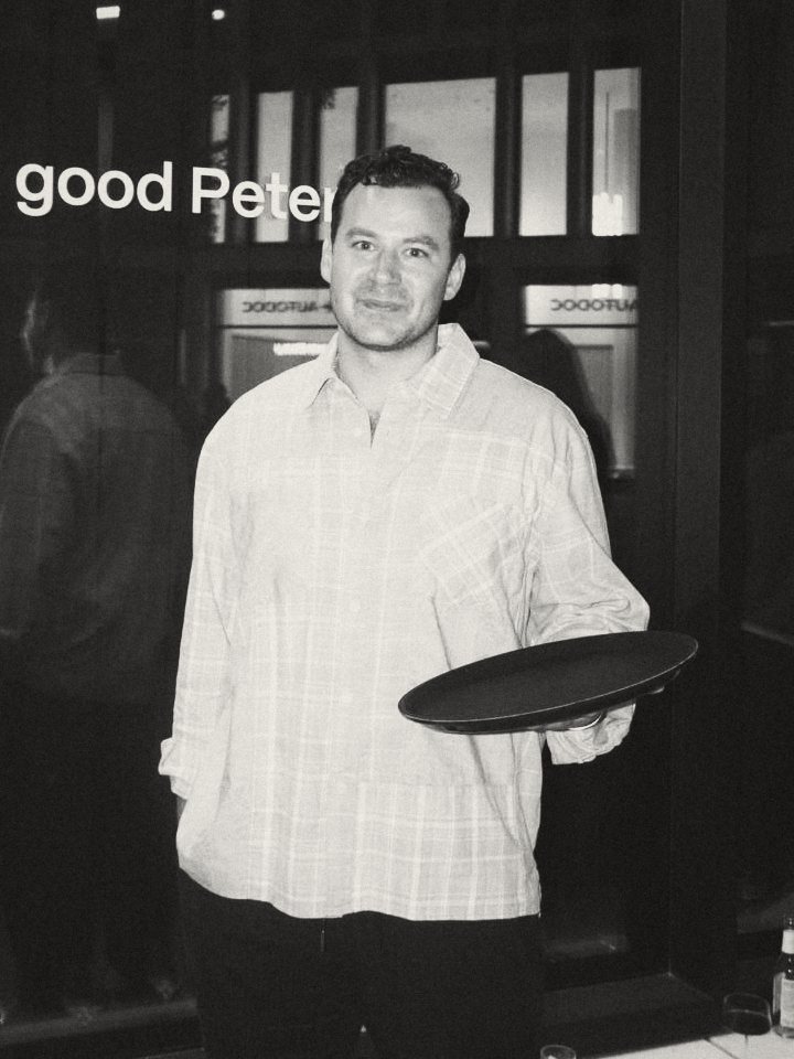 Peter, host, holding a serving tray